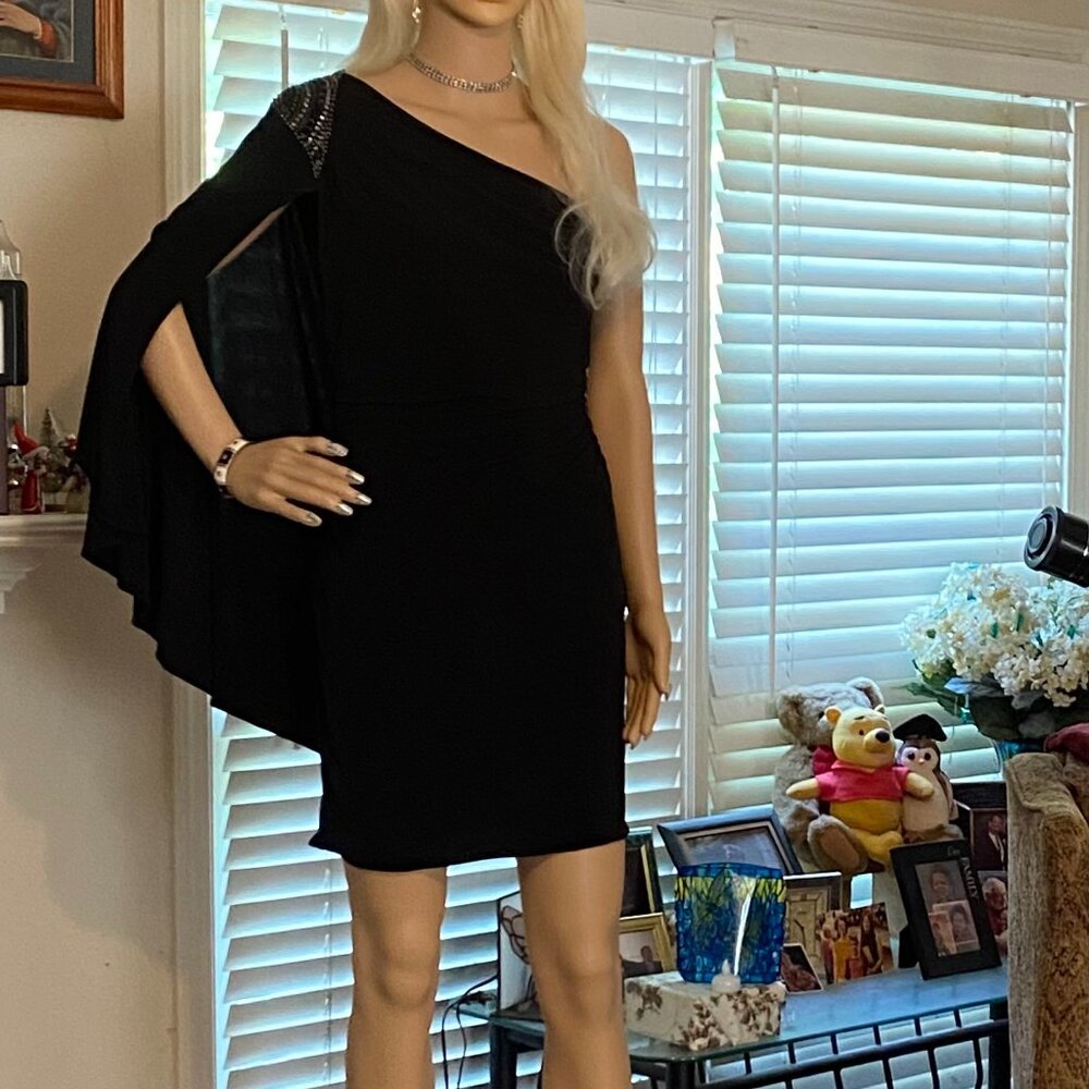 Black cape shoulder cocktail dress with  asymmetrical neckline